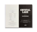 A hardcover copy of Crystal Lake: The Novel, a film book by A24, featuring a gray cover with the title and film imagery.