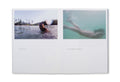 Open photography book "Hola Mi Amol" by SPBH Editions, showing black-and-white images on glossy pages.