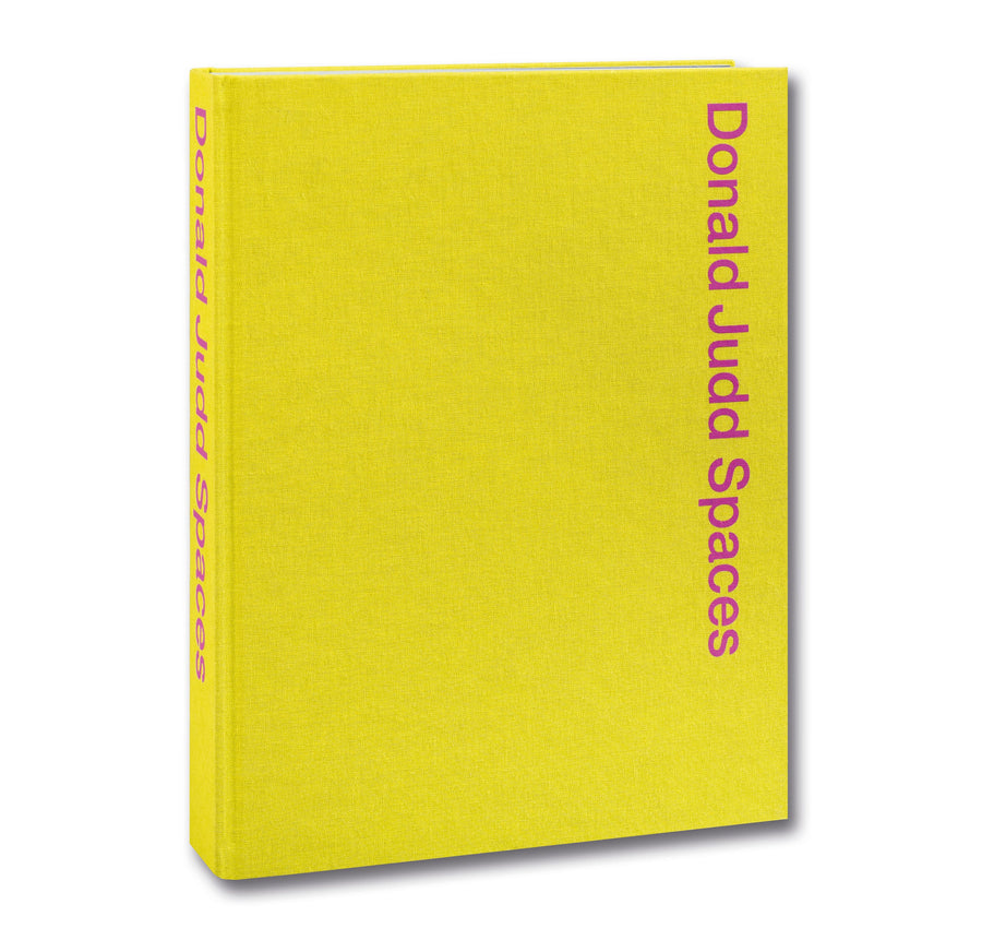 Open page from Donald Judd Spaces art book by Judd Foundation, featuring photographs and illustrations of Judd's minimalist designs.