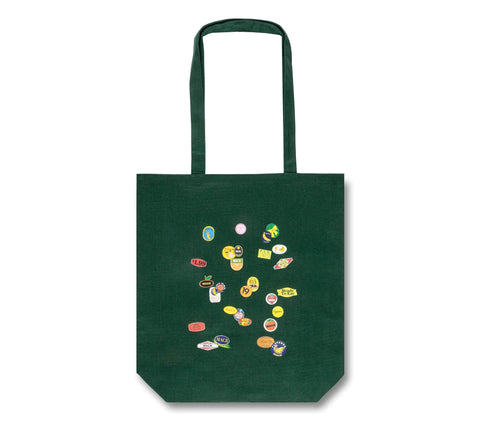 MACK tote bag featuring colorful fruit sticker design, made of durable fabric, with sturdy handles for everyday use.